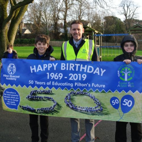 50th Birthday walk - Mr Thomas and 2 X Year 6 boys with banner 2